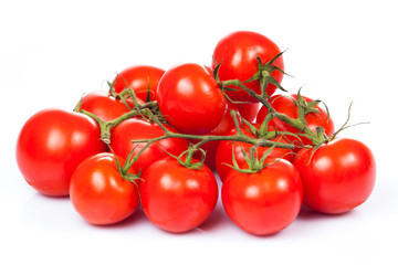 fresh tomatoes with green leaves isolated on white background