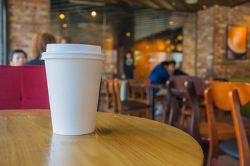 Fototapeta na wymiar White coffee cup in coffee shop