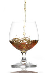 Pouring Brandy into Glass on White background