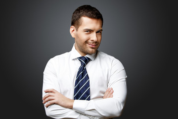 Handsome stylish businessman on grey background