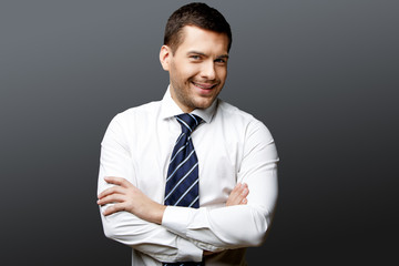 Handsome stylish businessman on grey background