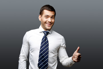 Handsome stylish businessman on grey background
