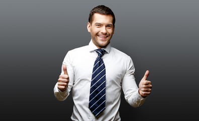 Handsome stylish businessman on grey background