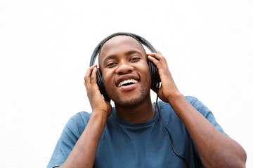 Happy young man listening to music on headphones