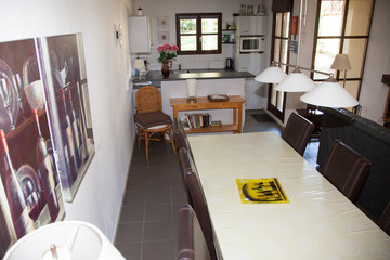 Warm interior of cosy living room with black sofas and tables.