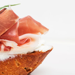 Prosciutto bruschetta with ricotta and arugula.