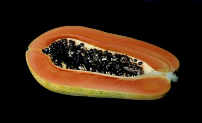 papaya on black background