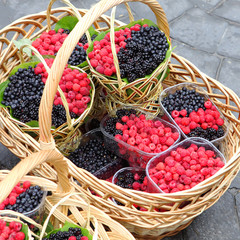Ripe raspberries and brambles in basket