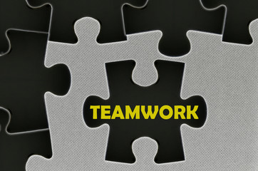 The white jigsaw puzzle written word teamwork