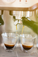 Professional espresso machine pouring strong looking fresh coffe