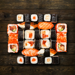 Set of sushi, maki and rolls isolated at wood