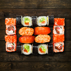 Set of sushi, maki and rolls isolated at wood