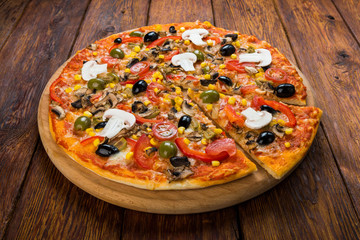 Delicious vegetarian pizza with tomatoes, mushrooms and olives