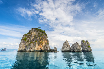Fototapeta na wymiar Thailand tropical island cliffs over ocean water during tourist boat trip in Railay Beach resort