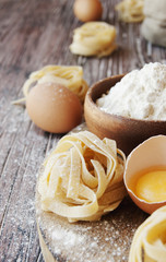 Uncooked pasta with flour on the table, selective focus