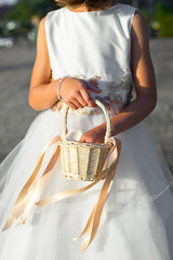 flower girl holding flower girl basket with petals