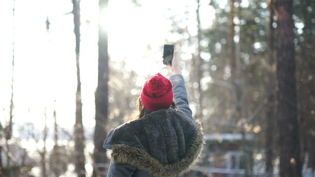 girl make a selfi in winter in sunset
