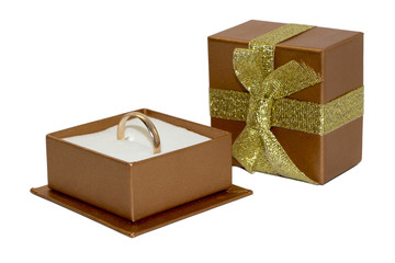 Golden wedding ring in open gift box isolated on white backgroun