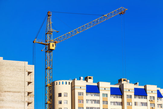 Closeup image of crane lifting bricks for civil building 
