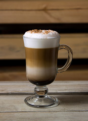 A cup of cappuccino on wooden table