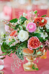 reception florals with peach and gold vase