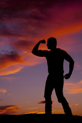 silhouete of a man one arm flexed other behind