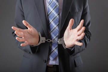 businessman in handcuffs arrested and isolated