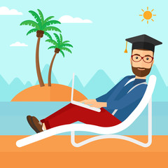 Graduate lying on chaise lounge with laptop.