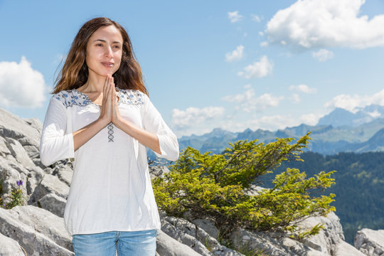 Woman meditating outdoors in summer