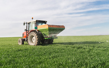  tractor fertilizing in field