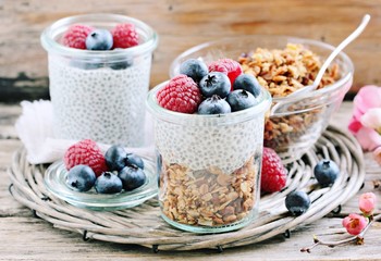 Superfoods concept : overnight chia pudding with homemade granola,fresh berries and honey. Healthy eating. Selective focus