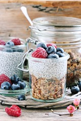 Superfoods concept : overnight chia pudding with homemade granola,fresh berries and honey. Healthy eating. Selective focus