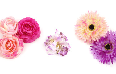 Floristics - droped artificial flowers on white background