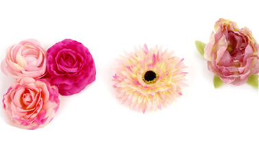 Floristics - droped artificial flowers on white background
