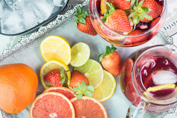 Pitcher and glass of popular wine -based beverage - Sangria and slices of citrus fruits.