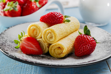 rolled pancakes with strawberries breakfast
