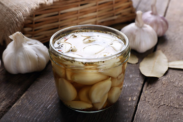 Garlic with spices on wooden table