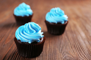 Chocolate cupcakes on wooden background