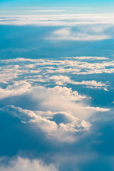 Above The Clouds. This picture was taken out of an airplane and shows the beautiful cloudscape in the evening light.