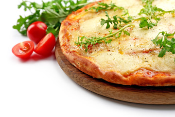 Pizza full of cheese on wooden board with vegetables isolated on white background, close up