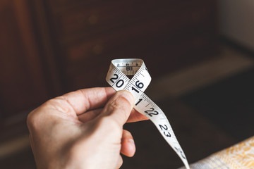 2016. Man hand holding sewing centimeter © glebchik
