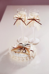 Pair of decorated wedding wineglasses and cushon with rings 