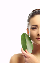 Portrait of beautiful woman with green leaf which isolated on white background, close up