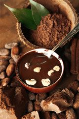 Aromatic cocoa harvest with tasty chocolate on wooden background, close up