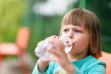 Child girl drinking water