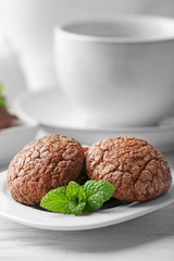 Chocolate chip cookie in plate with mint, closeup