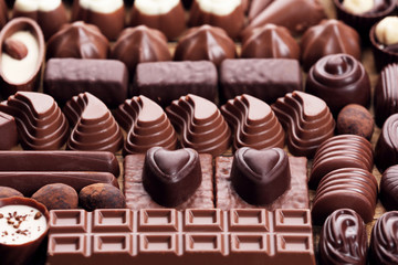 Assortment of delicious chocolate candies background, close up