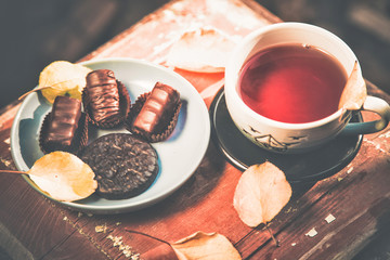 stylish vintage photo of tea with chocolates,
