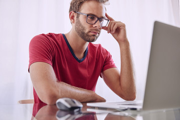 Man deep in concentration infront of computer
