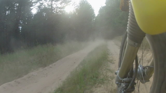 Riding motorcycle along the dusty road.